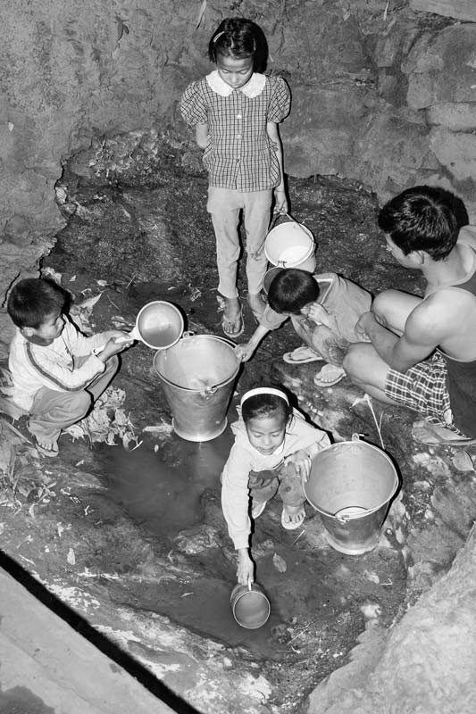 Rural Drinking Water Challenges - Scooping out scanty drinking water from an unprotected spring in Zunheboto district, Nagaland